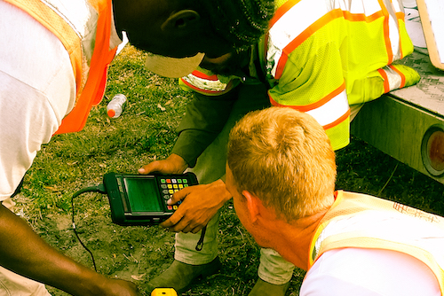 Engineers taking readings on instrument